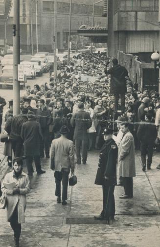 'Everybody's crazy'. This is only part of the mass of Beatle-lovers who descended on Maple Leaf Gardens today to get tickets for their heroes' appeara(...)
