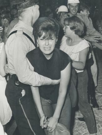 Fan of Beatles is restrained by police outside King Edward hotel where quartet stayed