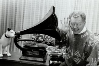 His master's voice: John E. Rutherford, past president of the Canadian Antique phonograph society, strikes a familiar pose with a 1905 Columbia outsid(...)