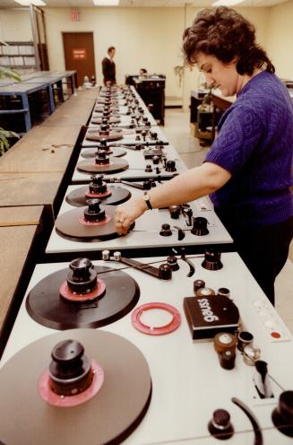 Sound Business: Jackie Kellas reloads recording machine in tape-duplicating room at CBS Records