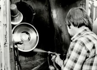 Gerry Blackmore applies a coat of silver to a lacquer record form