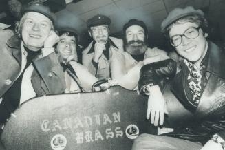Sporting chinese caps, The Canadian Brass members arrive at Toronto International Airport last night after two-week tour of China. We played 14 concer(...)