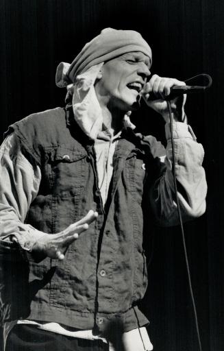 Peter Garrett: Leader of the Australian quintet Midnight Oil last night protected his shaved head from the wet, cold air at the CNE Grandstand
