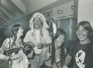 Dressed as Indians, three happy fans of the Rolling Stones enjoy the concert in Maple Leaf Gardens