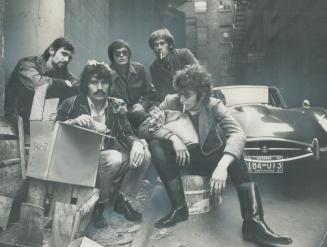 The city Muffin Boys Ltd. Amid the Garbage of their Toronto back-alley 'Headquarters' Left to right, Peter Walmsley, Rich Whyte, Art Charpentier, Pete(...)