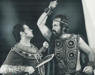 In a climactic moment in Aida, Amonasro captured Ethiopian King (right), threatens Egyptian Captain Radames