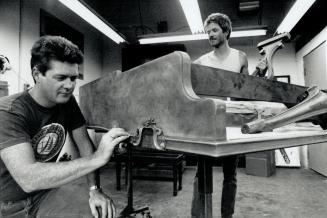 Gary and Don Sevier restore a grand piano at Robert Lowrey's Piano Experts
