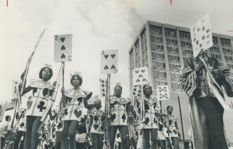 Opening Caribana '70, the fourth annual West Indian festival at the Toronto islands, participants in costume parade from Varsity Stadium on Saturday. (...)