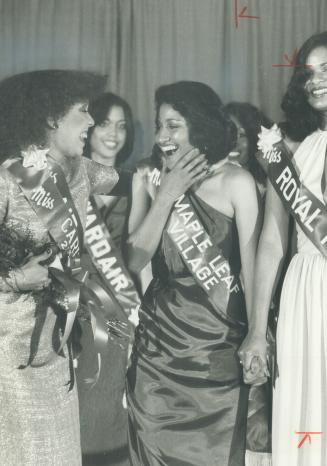 Miss Caribana. Winner of the annual Miss Caribana beauty contest is a smiling Sherene Shaw, Miss Maple Leaf Village, right, accepting congratulations (...)