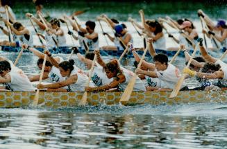 Women's College Hospital crew, foreground, competes against Royal Bank team in Dragon Boat Race Festival at Centre Island yesterday