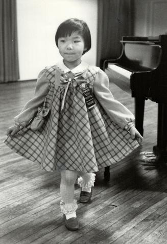 Baby at the grand: Karen Choi, 5, of Agincourt, one of the youngest contestants in the Kiwanis Music Festival, plays her set piece, a sonatina, with skill, then curtsies politely to the adjudicator