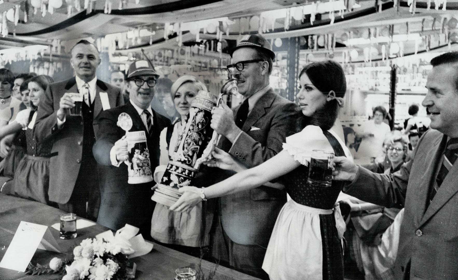 To Shout of Prosit, a German toast to good health, Mayor William Dennison raises five-quart stein of beer at opening last night of Metro's three-day O(...)
