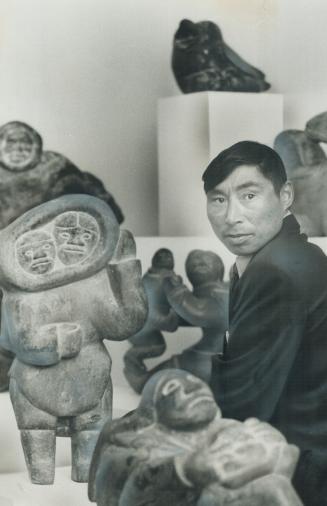 Surrounded by his works of art is Eskimo sculptor Axangayu, who was in Toronto earlier this week for the opening of his one-man show at the new Innuit(...)