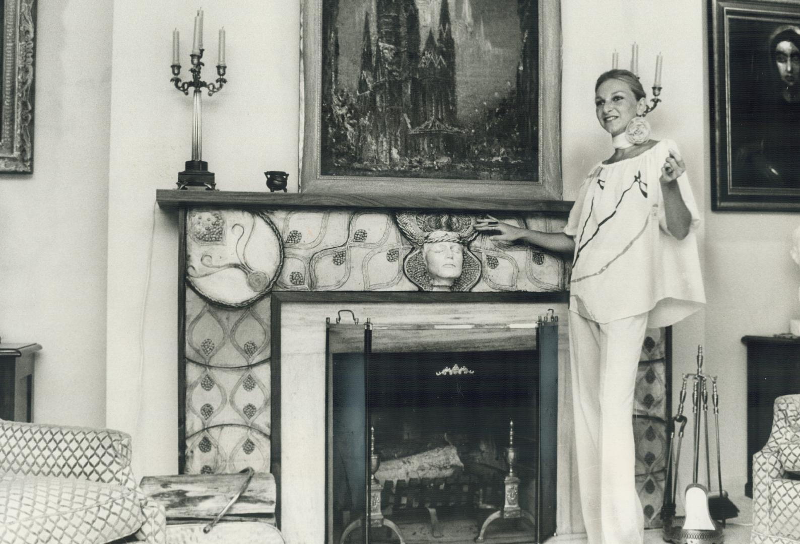 Standing beside the fireplace she designed, in the George Benjamin home on Parklane Circle, Susan Ancerl wears another Ancerl original - an outfit she(...)