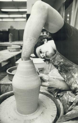 The skilled hands of Toronto artist Keith Campbell carefully shape a porcelain vase