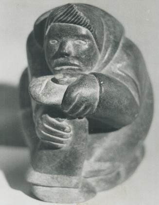 Titled woman with a drill. Soap stone carving is on display in Toronto this week