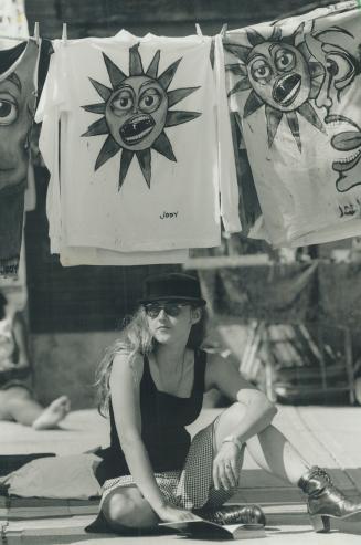 Artist Jody Boehnert of Toronto, left, felt the heat of more than one sun under her solar creations in the Beaches near Donald Summerville pool