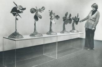 Cast aluminum sculpture by Jim Dine shows the gradual tranformation of a plant from its vulnerable appearance to a reasonalby convincing electric fan.(...)