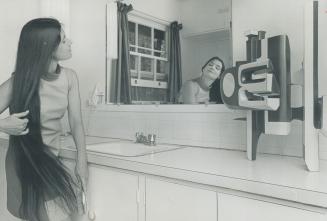 Now we've heard of everything - sculpture in the bathroom! Patricia Fulford brushes her long tresses in an artistic setting