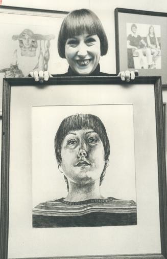 Self-Portrait is held by artist Sally Hopkins at the opening of her show in the art gallery of Eatonville Library