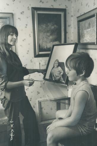 Artist Janice Parkins paints one of her children