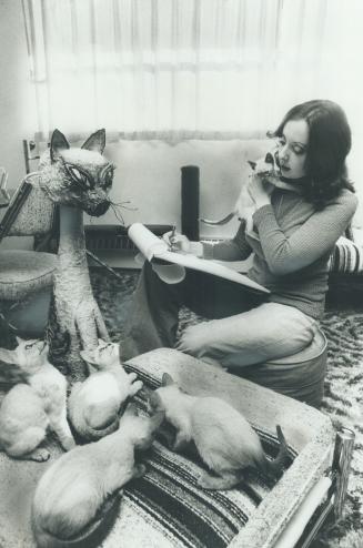 Animal portraitist Suzanne Thyer has her hands full with curious cats as her pet kittens demand equal time