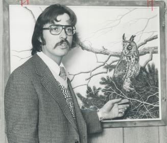 Artist Gary Low with his painting of a horned own, one of his works which is hanging at the McMichael Gallery at Kelinburg. Low will go to great lengh(...)