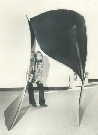 Penelope Dixon of the Mirvish Gallery takes a closer look at one of five pieces of sculpture by Robert Murray now on display at Markham St. gallery. S(...)