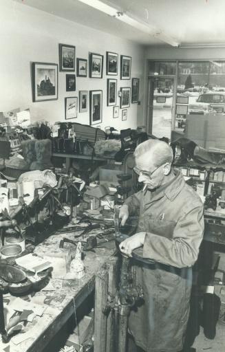 His paintings surround him as 57-year-old Anton Vandelft works in his West Hill shoe repair shop