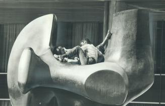 Art lovers. The hospitable curve of the Archer, the Henry Moore sculpture at Toronto City Hall, was just too inviting for these young lovers to resist(...)