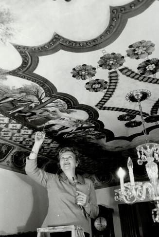 Toronto's Michelangelo: Elizabeth Mueller stands on a stepladder to touch up some of the figures in a painting she did on the ceiling of her home which took 3 1/2 years to complete