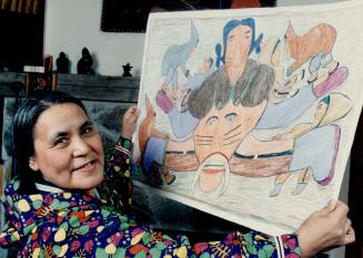 Preseved forever: Ruth Annaqtuusi Tulurialik shows off one of her colored pencil drawings depicting traditional inuit life