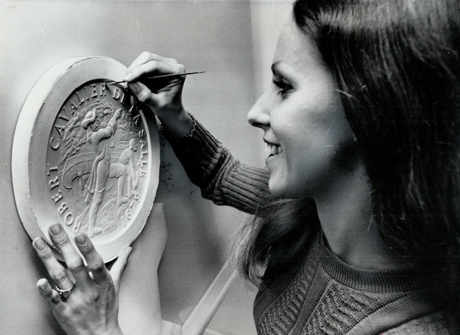 Working in a private Mint, artist-sculptor Marion Wakeling puts the finishing touches on a casting for a medal at Wellings Mint in Rexdale. The mint i(...)