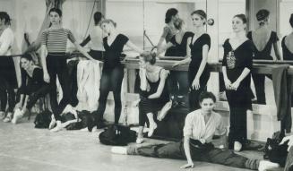 Left, members of the corps de ballet rest between workouts