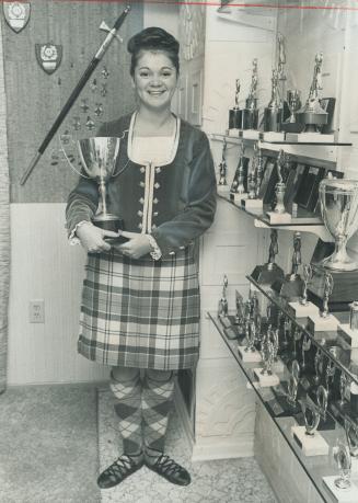 Trophy- Laden Shelves - more than 400 awards - mark the progess of 17-year-old Highland dancer Lorraine Spiers