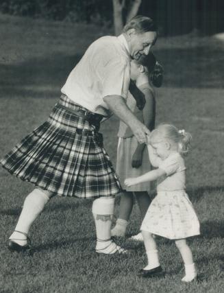 Footloose: Cyrl Hollingshead of Leaside and 3-year-old Laurie Forsyth of Mississauga enjoy traditional Scottish country dancing in Sunnybrook Park