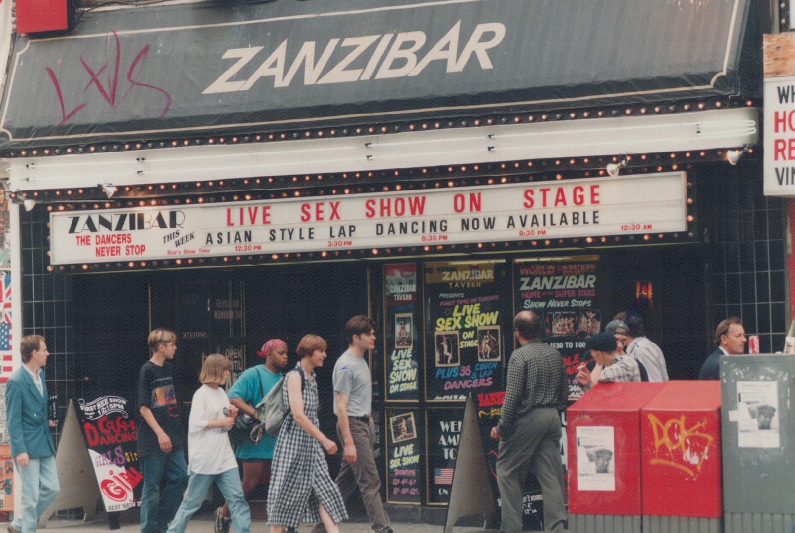 Live sex show: Yonge St. shoppers pass the Zanzibar Tavern, which boldly advertises what critics say is an inevitable progression from lap dancing