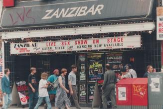Live sex show: Yonge St. shoppers pass the Zanzibar Tavern, which boldly advertises what critics say is an inevitable progression from lap dancing