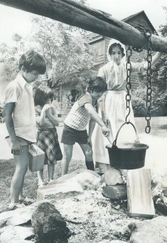 Learning a pioneer skill, Cooking over an open fire is one of the pioneer day skills demonstrated at Black Creek Pioneer Village. Watched by chef Barb(...)