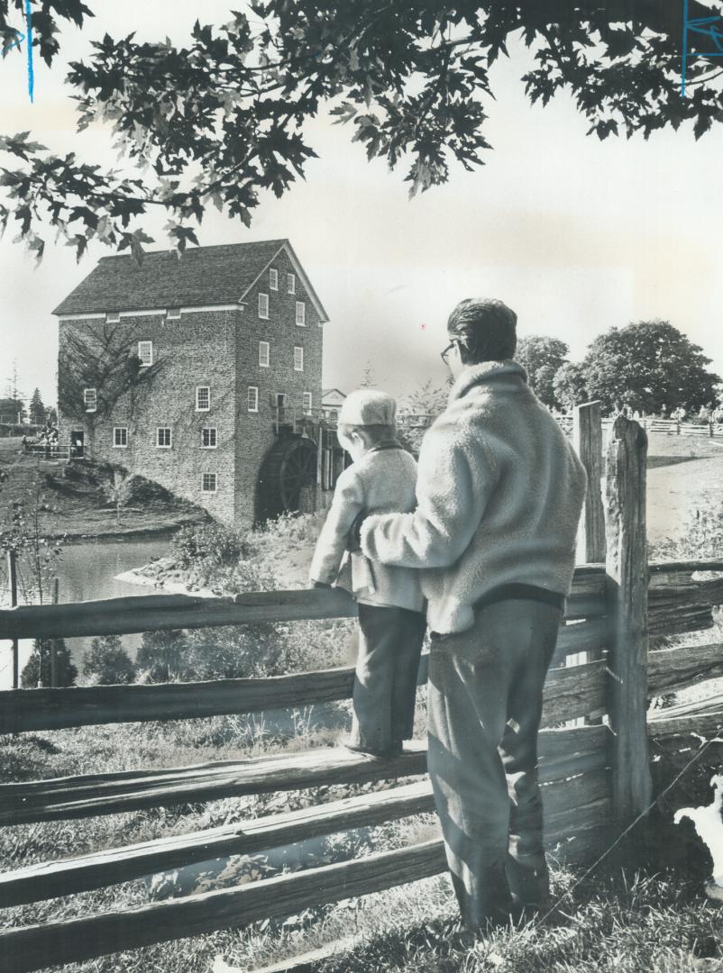 A dream, this man and his son ponder the life of Ontario pioneer wander through Black creek Pioneer Village at Jane St