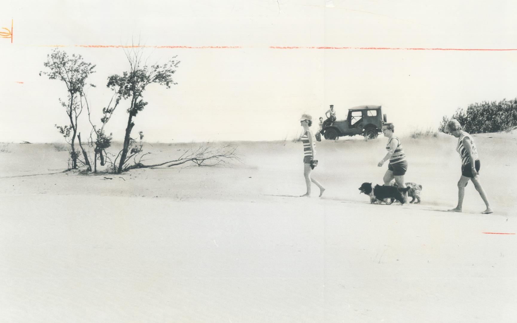 Crew of army jeep watches as tourists go on safari on the Carberry desert right in the middle of Canada's breadbasket