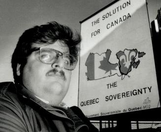 Constitutional Solution: Ivano Veilone stands near Toronto billboard today advertising Quebec separatist group's solution to Canada's constitutional crisis ? a sovereign Quebec