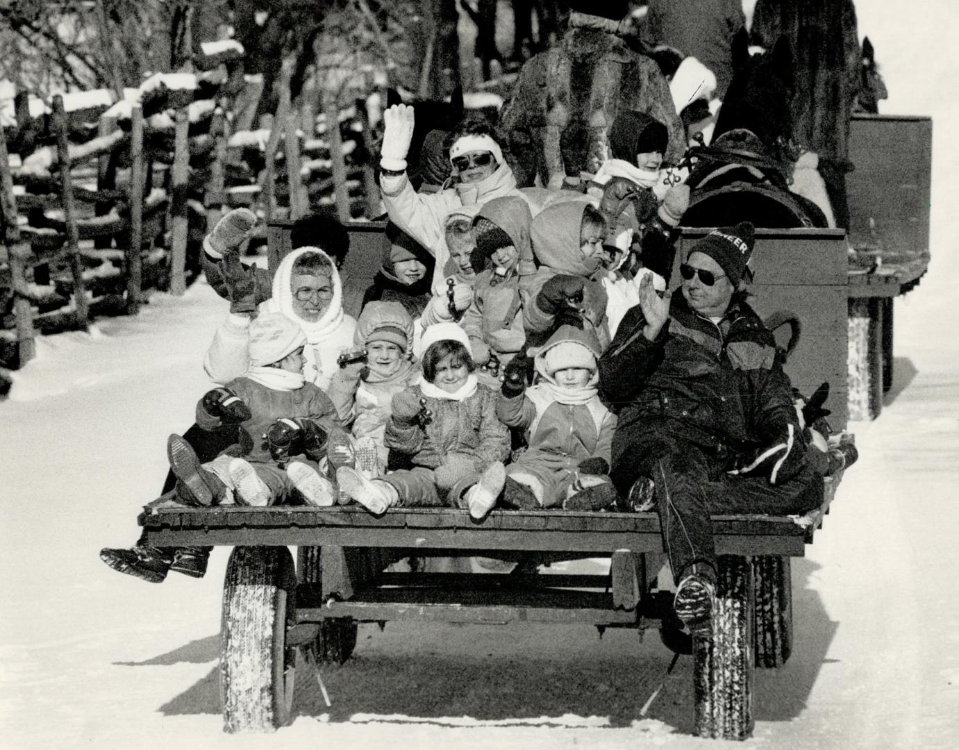 All bundled up for a sleigh ride, Enjoying a horse-drawn sleigh ride on a sunny afternoon is a group from Etobicoke's Wellesworth Junior Public School(...)