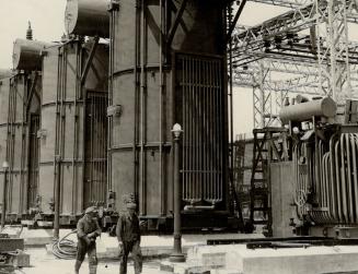 A battery of giant transformers (above) at the Beauharnois power plant-which make ordinary electrical apparatus look kids' toys. Generator room (right(...)