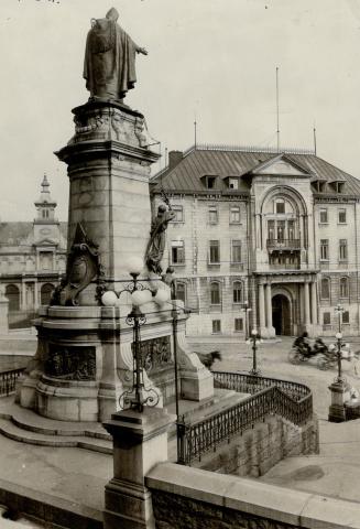 The Cardinal's palace at Quebec with a part of seminary on the left and in the foreground the statue of Bishop Laval