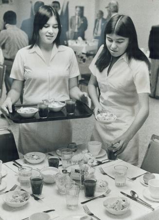 Work at the house of Concord for Patsy Isbister, left, and Joyce Farrar, involves setting table for a Rotary Club luncheon. The two 18-year-old girls (...)