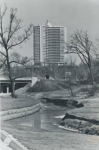 The Don River flows quietly beside Don Mills Rd