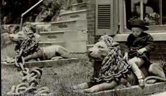 These two chained lions located in front of the Murray Crawford office at Campbellville are over 40 years of age and have stood in their present position for more than 20 years