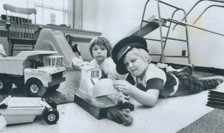 All kinds of playthings are provided for the boys and girls in junior kindergarten at Cameron Public School, where 4-year-old Petri Stepanoff plays wi(...)