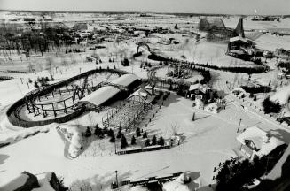 Walting for spring, Skeleton of amusement park pokes through the snowy blanket in top night photo